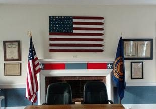 The Post 86 meeting room with American and state flags above the fireplace